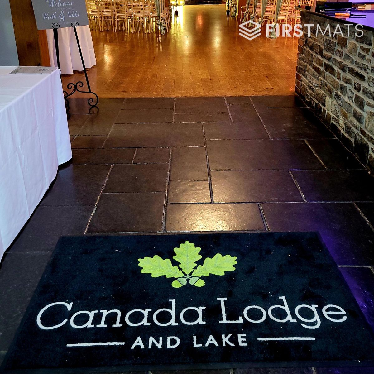 Floor mat with 'Canada Lodge and Lake' logo on a tiled floor.