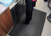 Black PinnacleMat anti-fatigue floor mat designed for kitchen and catering environments to provide comfort and reduce strain for standing workers.