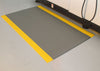 Grey and yellow AtEase comfort mat for industrial use on hard floors.