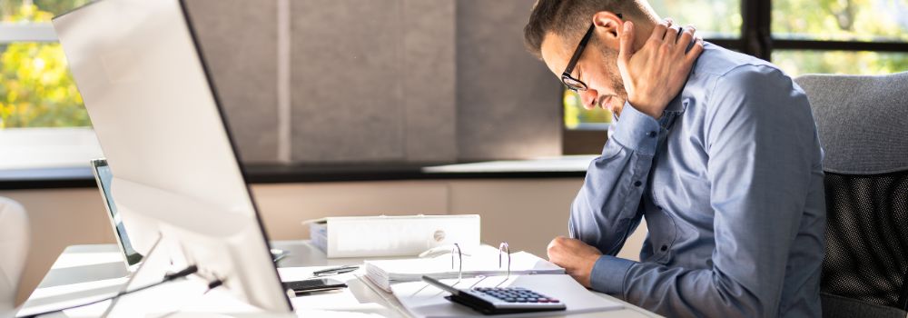 Man with neck pain at desk