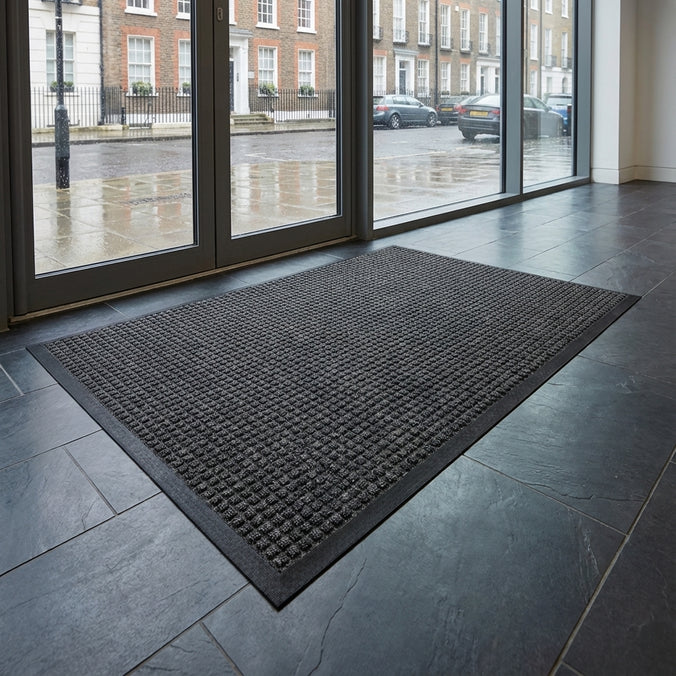 Large grey Aquaprotect Door Mat in a streetside entrance