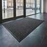 Large grey Aquaprotect Door Mat in a streetside entrance