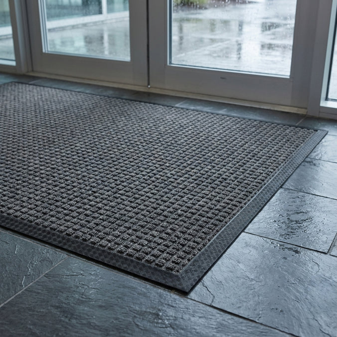 Closeup of the grey Aquaprotect mat on a tiled floor