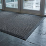 Closeup of the grey Aquaprotect mat on a tiled floor
