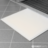 White tacky mat on a grey tiled floor