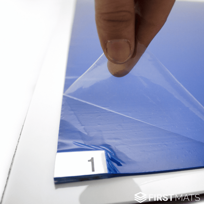Peeling a layer off a blue tacky floor mat