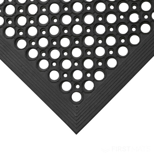 Black rubber mat with a pattern of circular holes on a white background