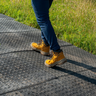 Person walking across ground protection tiles