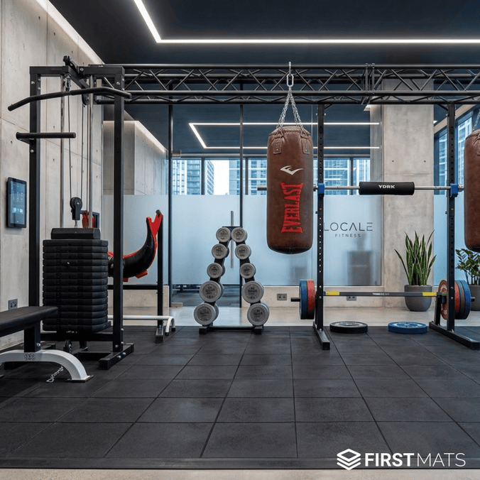 Modern gym showing equipment on interlocking rubber mat tile flooring