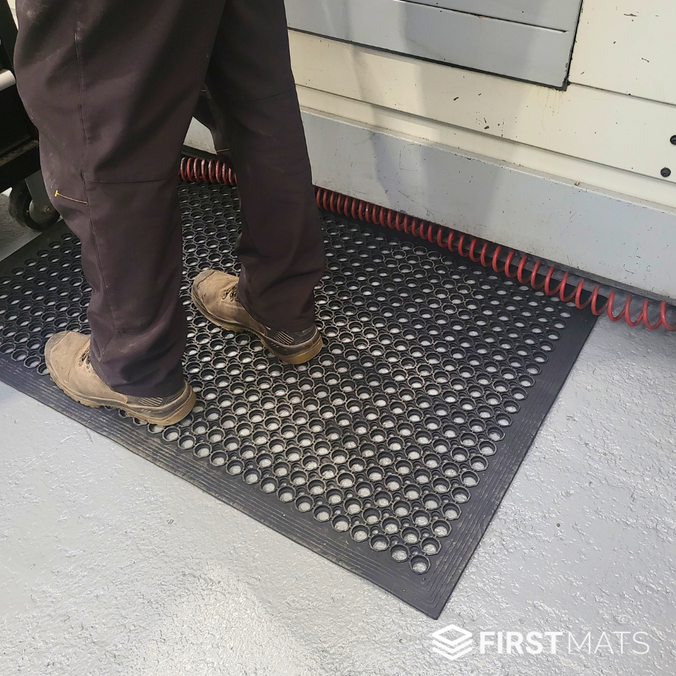 Standing on a rubber non-slip anti fatigue mat