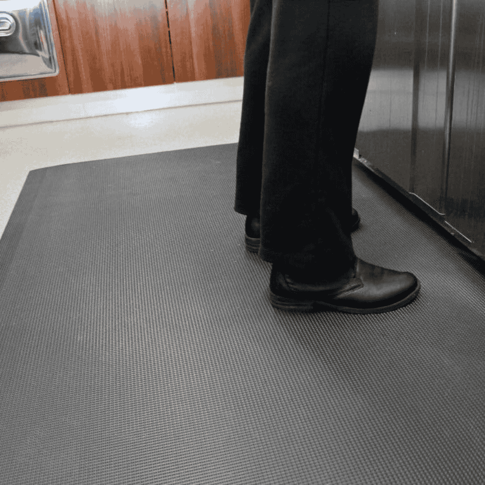 Person standing on the Kitchen and Catering floor mat in a cafe 