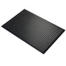 Black rubber mat with a textured surface on a white background