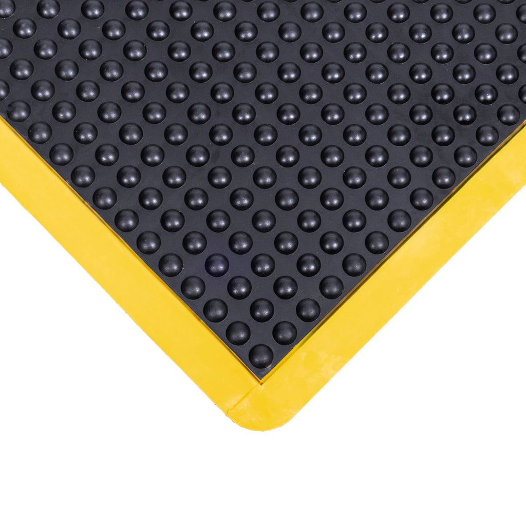 Black bubble textured mat with yellow border on a white background