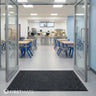 A modern canteen entrance with a plush mat