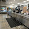 Grey floor mat in a canteen by a service counter