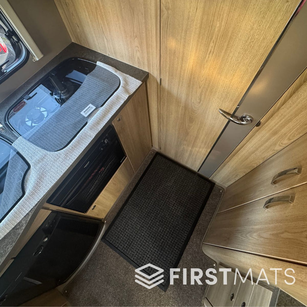 Motorhome interior with a grey heavy-duty floor mat