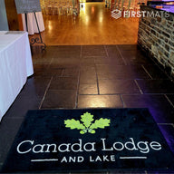 Floor mat with 'Canada Lodge and Lake' logo on a tiled floor.