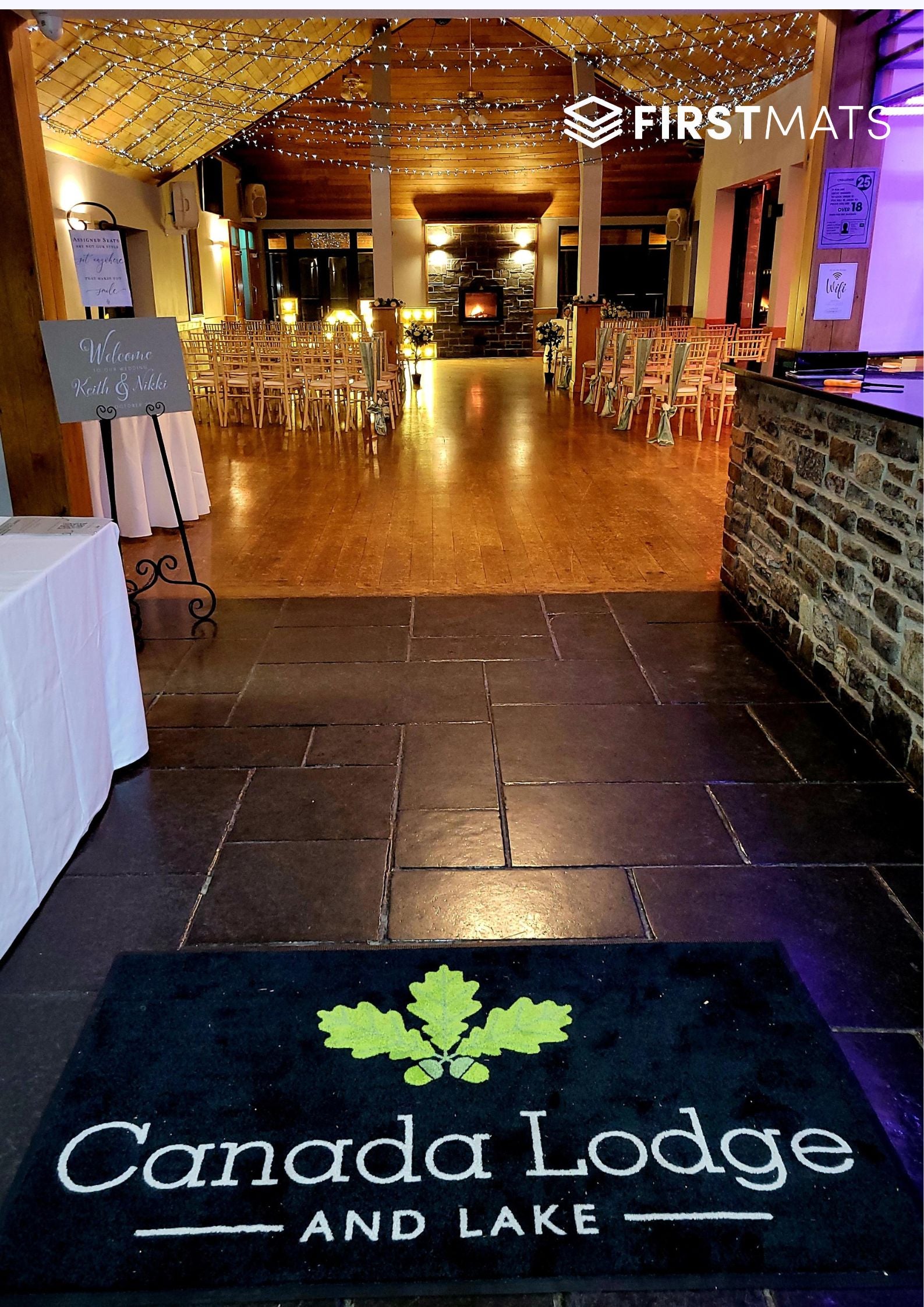 Event venue with tables and chairs set up, featuring 'Canada Lodge and Lake' logo on a mat.