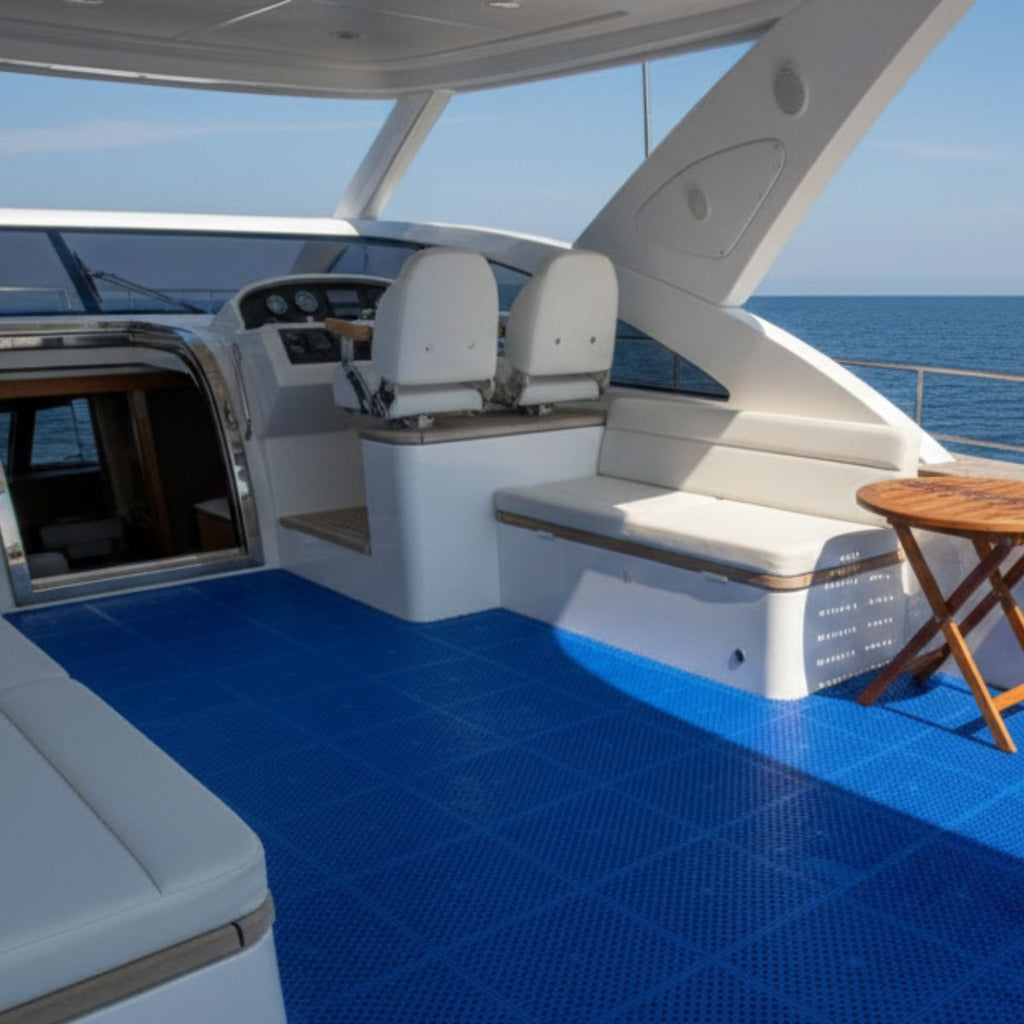 Deck of a luxury yacht with blue flooring and white seats.