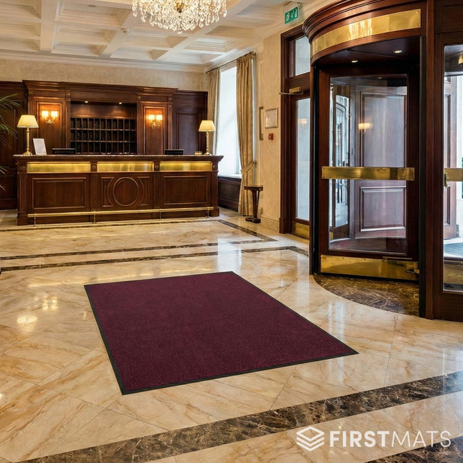 Dark red entrance mat in hotel lobby