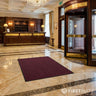Dark red entrance mat in hotel lobby