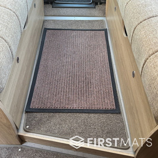 Textured brown scraper mat inside a motorhome