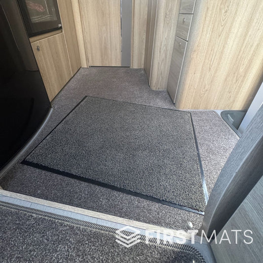Grey plush mat in a motorhome interior