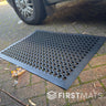 Black rubber floor mat with honeycomb pattern outside a motorhome
