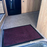 Red mat on a carpeted floor in a moorhome.