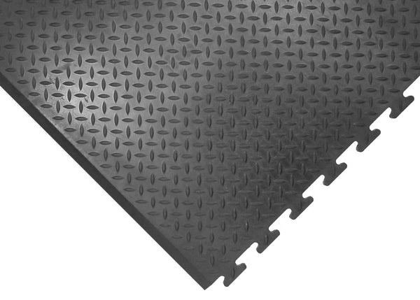 Interlocking black anti-fatigue mat with oil-resistant surface designed for industrial use