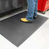 Black anti-fatigue PinnacleMat with oil and fire resistance in industrial environment.