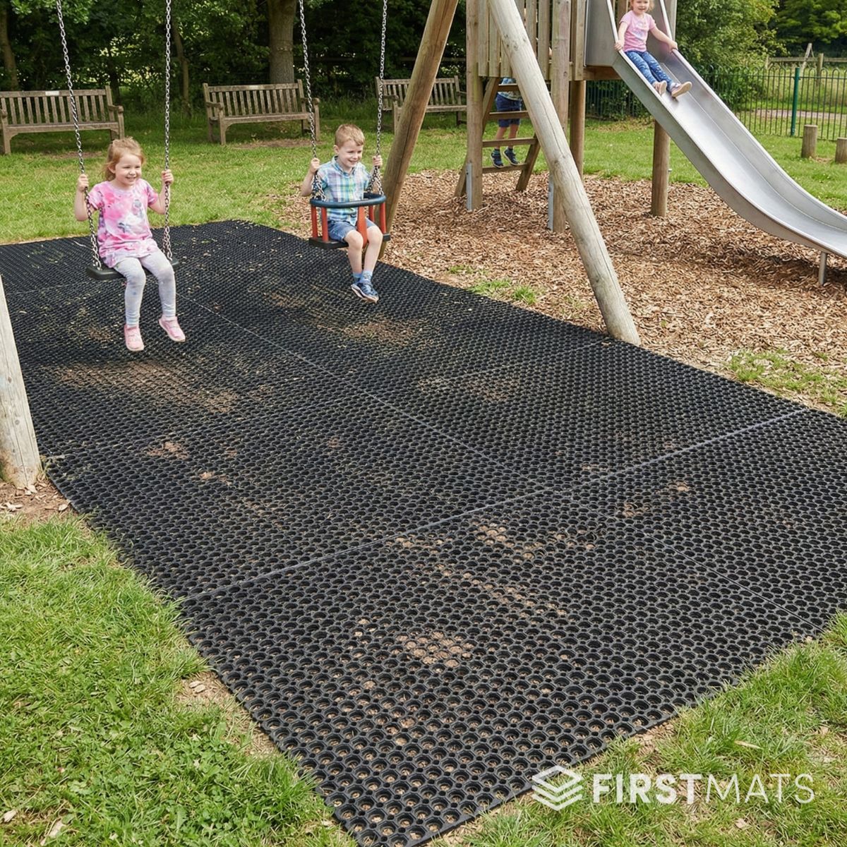 Children playing on a playground with a black rubber mat covering the ground.