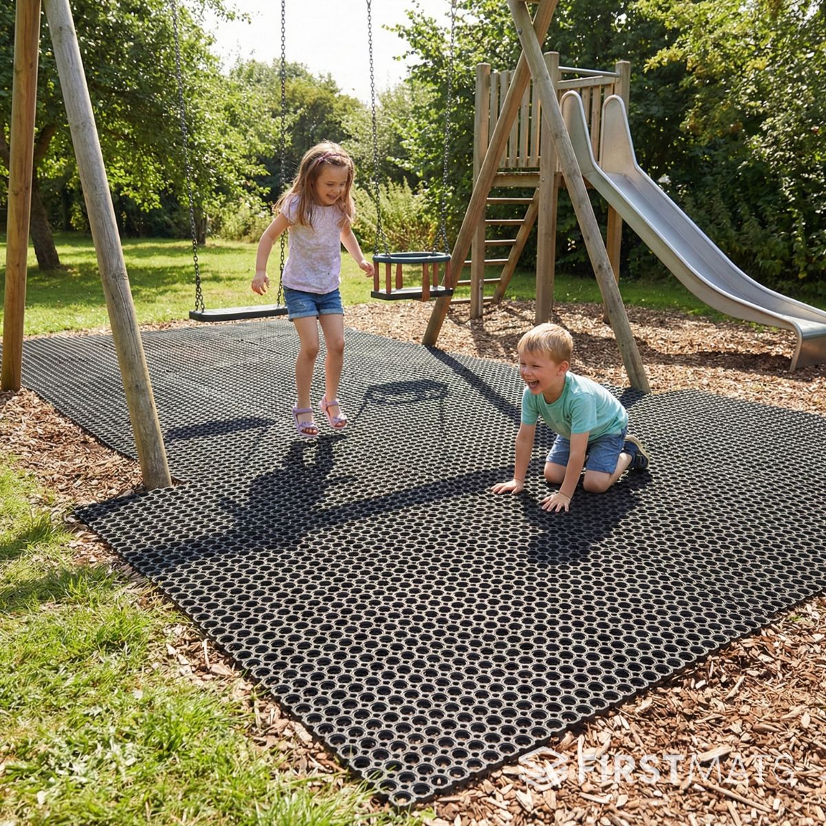 Children playing on a playground with a textured safety mat.