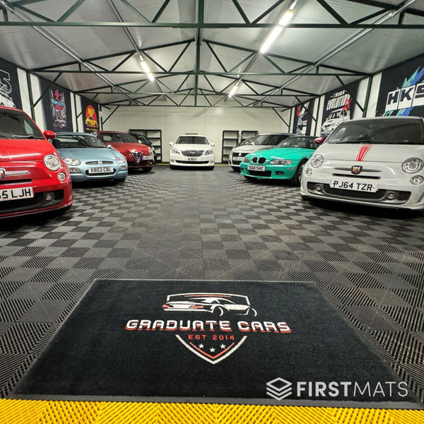 Graduate Cars logo mat in car garage