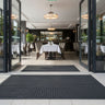 Heavy-duty entrance mat outside a modern restaurant