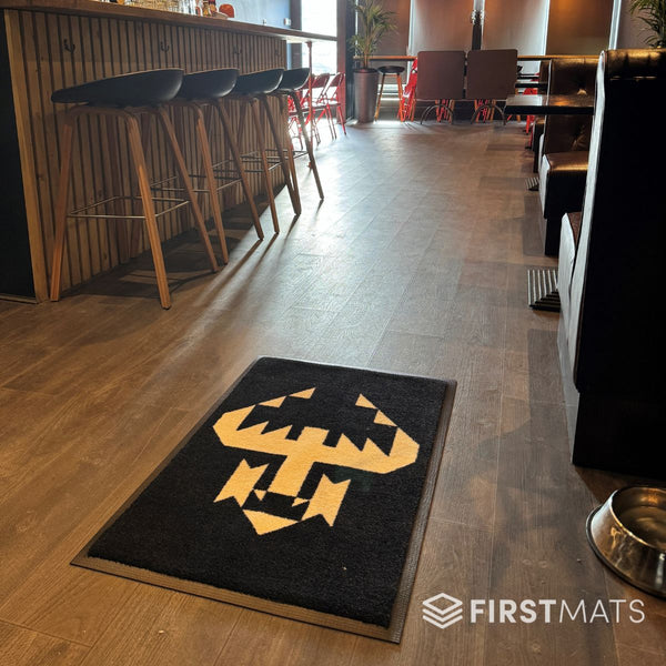 Black and yellow logo mat in a restaurant