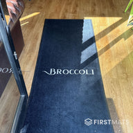 Black logo mat in a restaurant / Broccoli Cafe