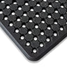 Close-up view of a black rubber utility mat with a pattern of circular holes designed for drainage.
