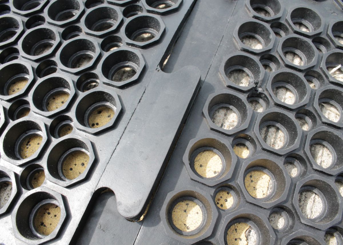 Black interlocking anti-fatigue industrial mats for comfort and reduced leg strain.