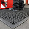 Industrial anti-fatigue mat with debris-capture design